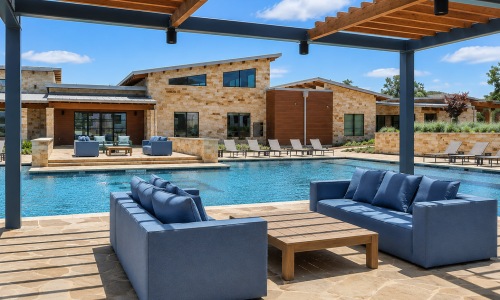 2 couches and a table poolside under a gazebo