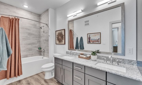 Bathroom with dual vanities in a 3-bedroom apartment at Pyland Ranch